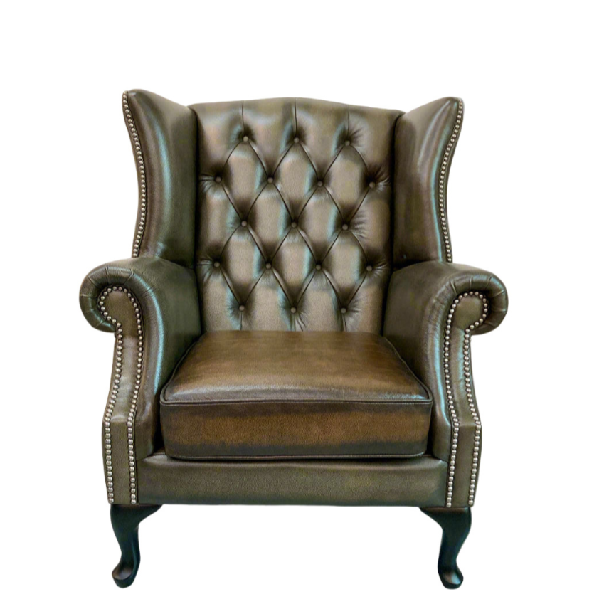 Brown leather armchair with tufted backrest on a white background