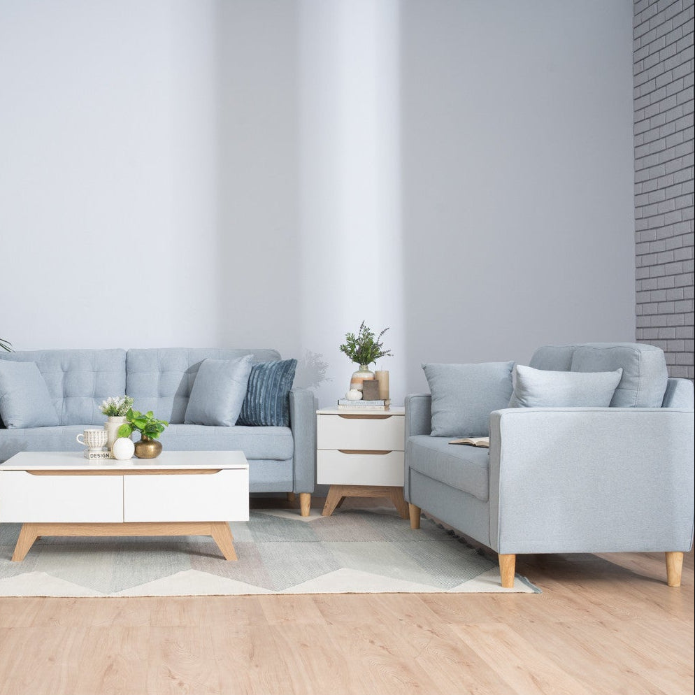 Modern living room with gray sofa, armchair, and coffee table.