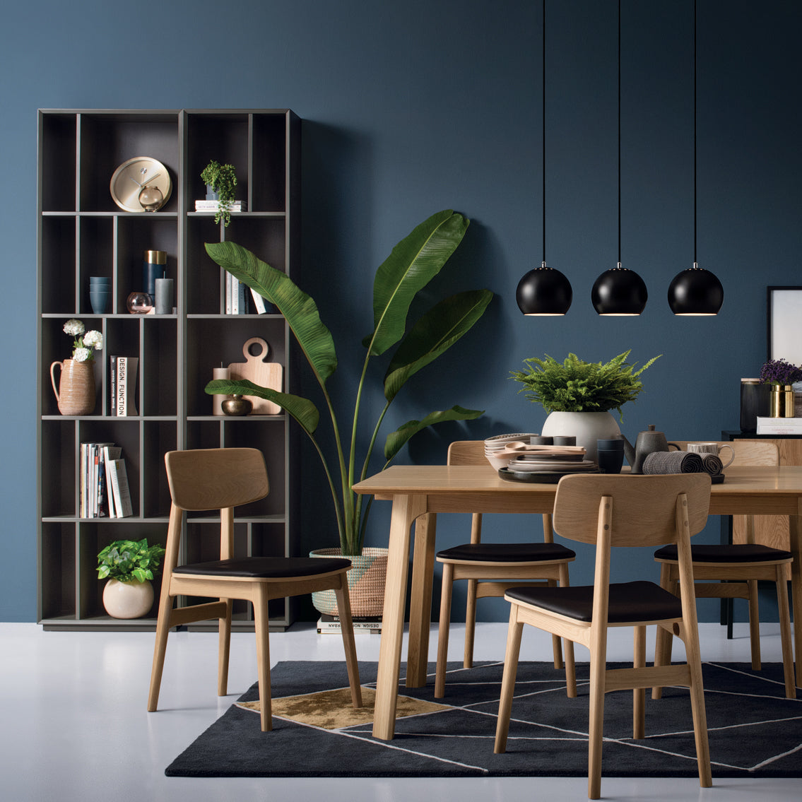 A black high bookcase with multiple shelves, designed for storage of books and display items.