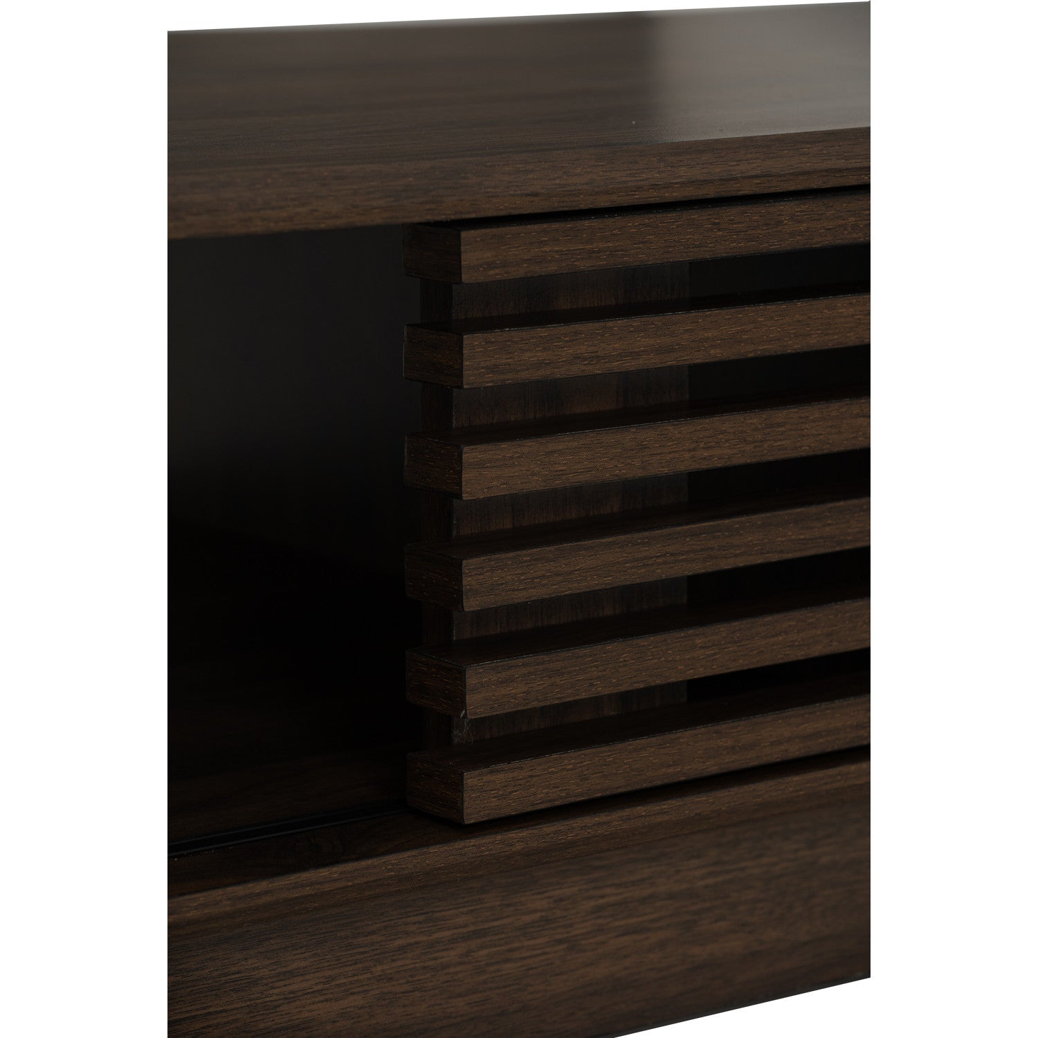 Close-up of a dark brown wood cabinet or sideboard with a slatted front panel and visible wood grain texture.