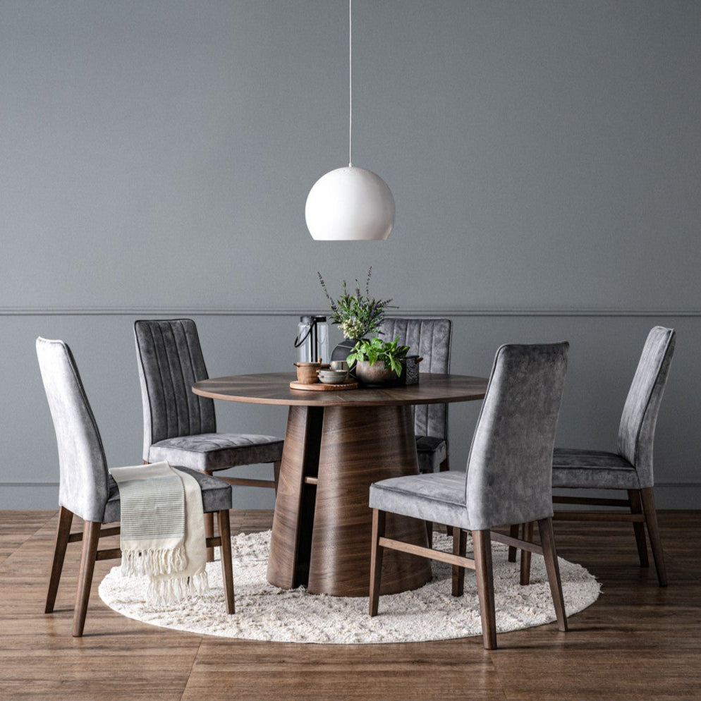 Dining room with a wooden table and gray chairs against a gray wall.