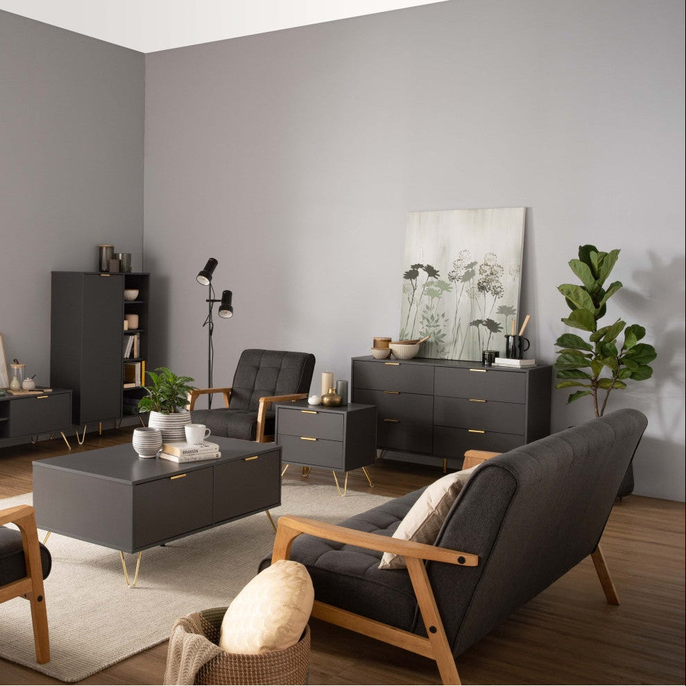 Modern living room with gray sofas, coffee table, and bookshelf.
