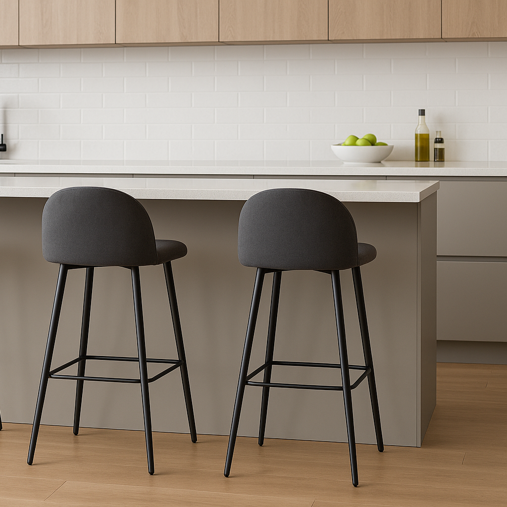 Three gray bar stools with black legs in a modern kitchen setting.