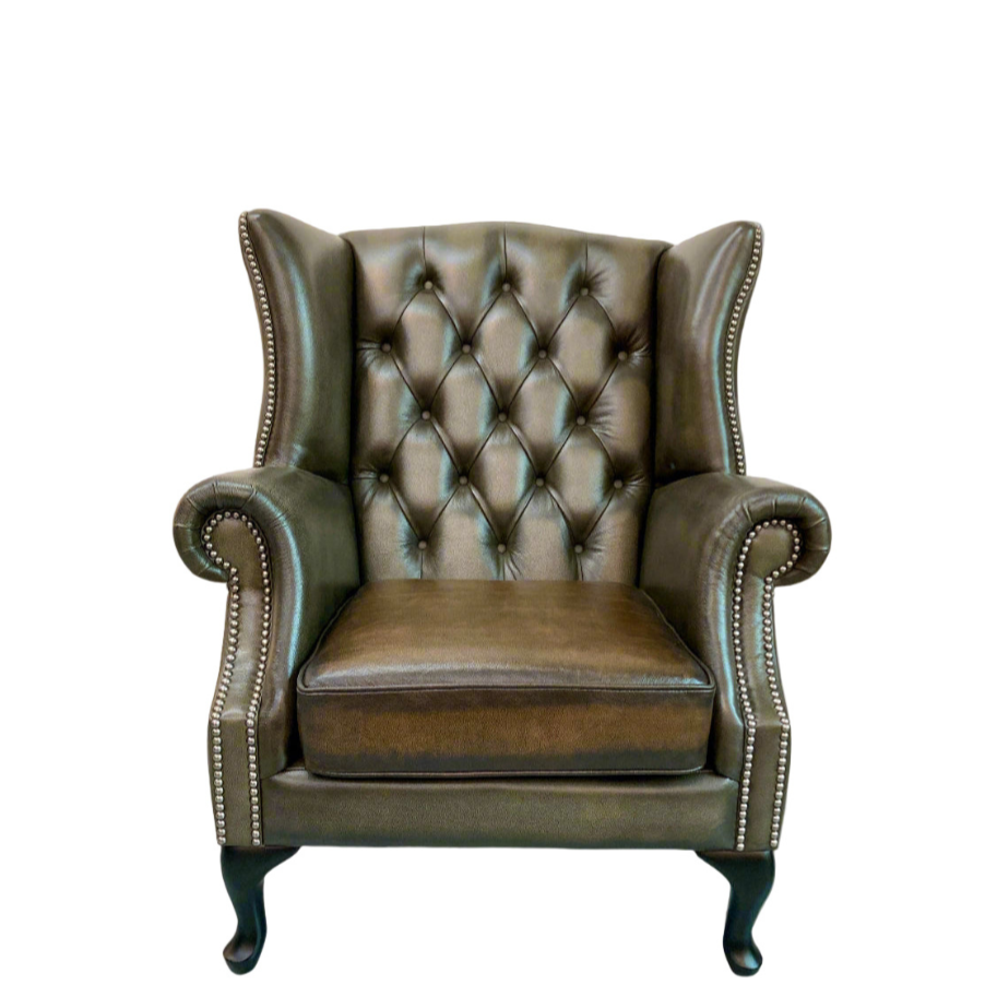 Brown leather armchair with tufted backrest on a white background