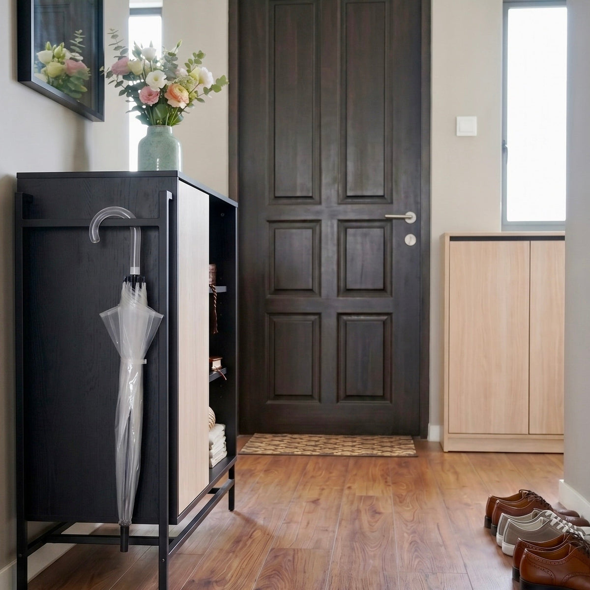 Foyer with a black umbrella stand holding an umbrella, wooden door, and shoes on the floor.