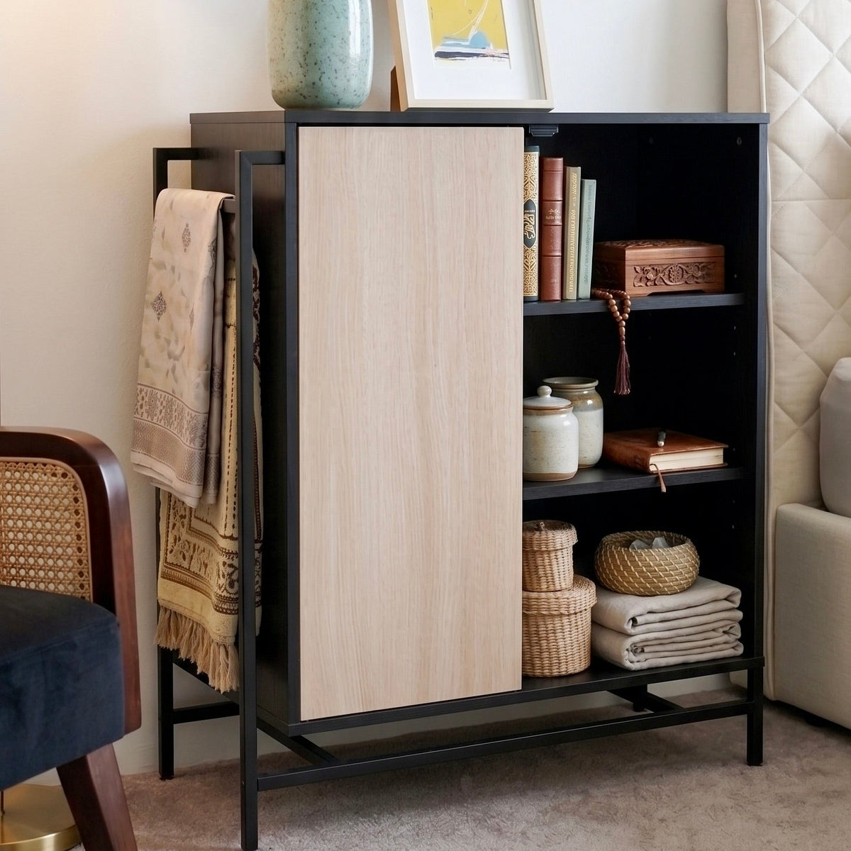 Black bookshelf with decorative items in a living room setting