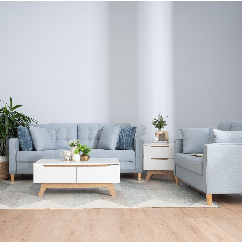 Modern living room with gray sofa, armchair, and coffee table.