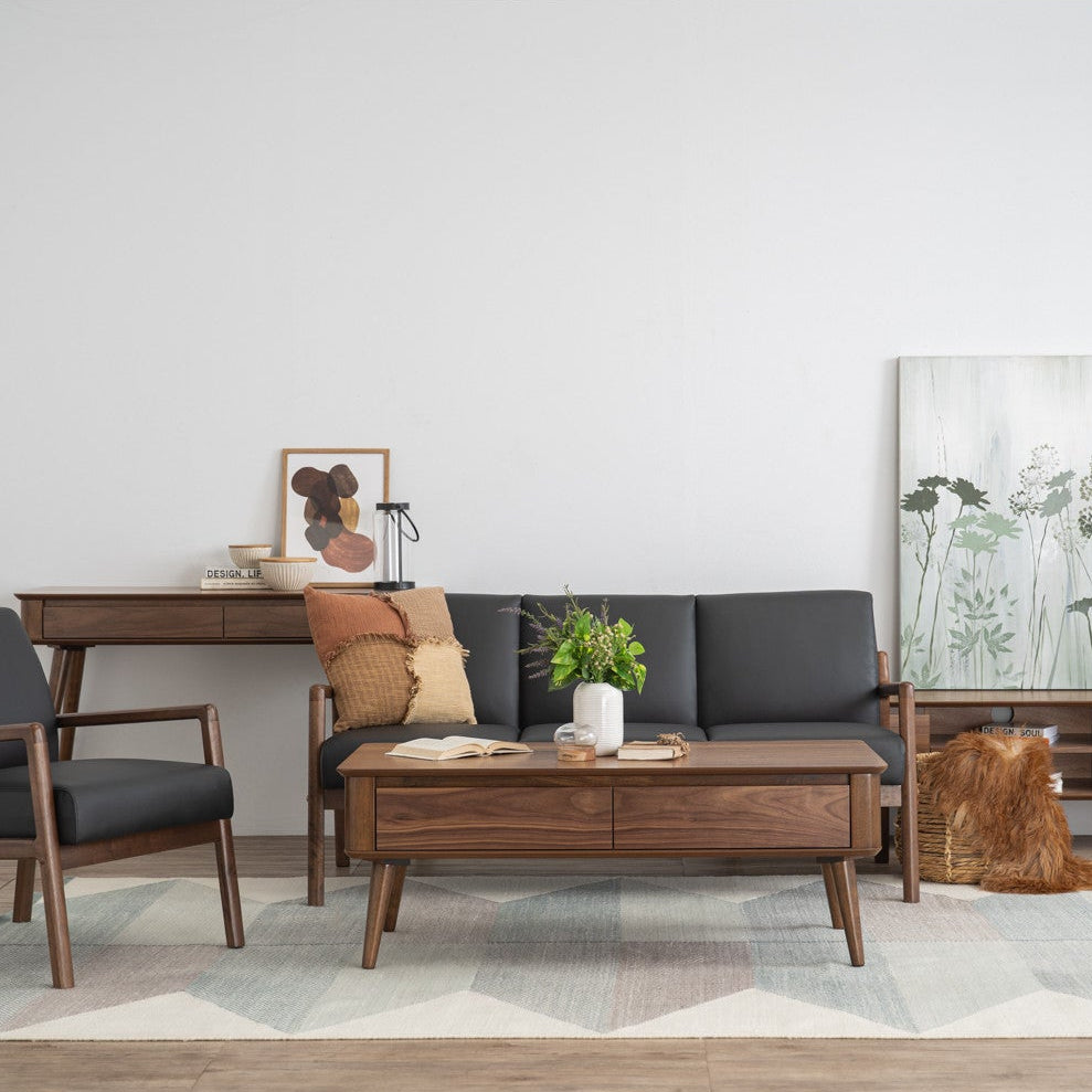 Modern living room with gray sofa, wooden coffee table, and armchair on a light gray rug.
