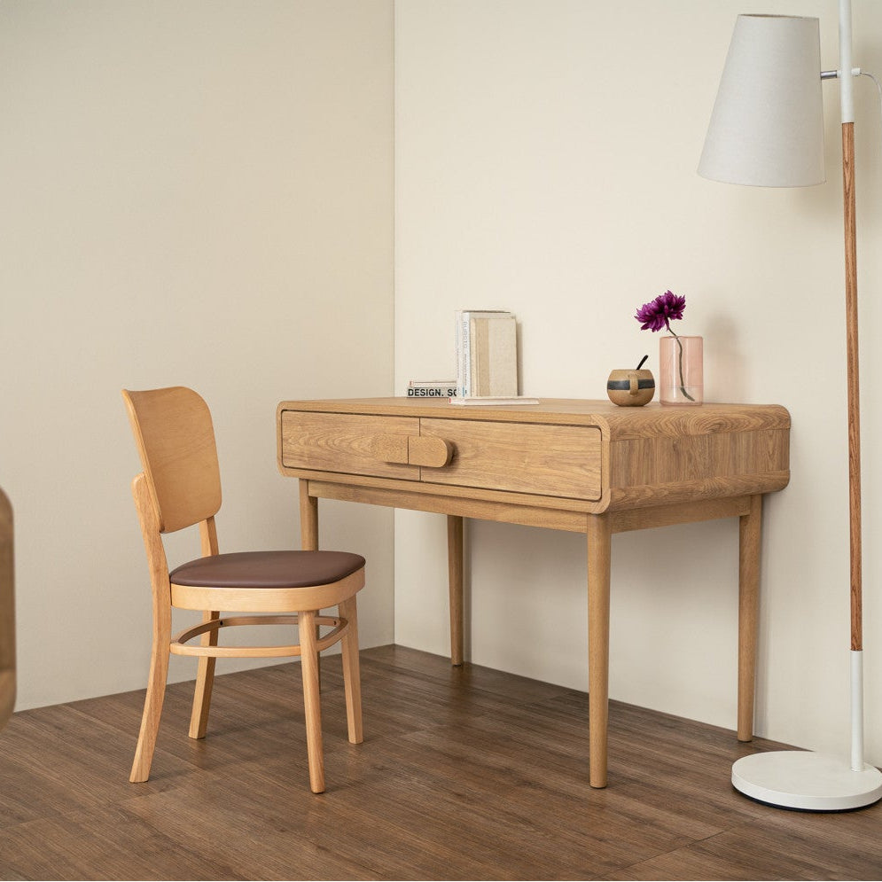 Wooden desk with chair in a minimalistic room setting