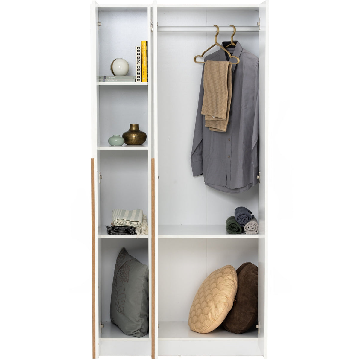 A tall white wardrobe or closet organizer with two doors, shown open and styled with a gray shirt, tan pants on a hanger, books, vases, folded textiles, and pillows inside.