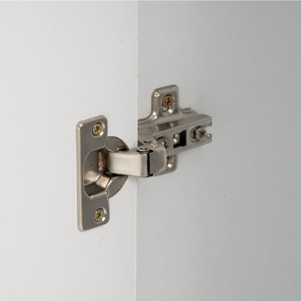 Metallic door hinge on a white door with a gray background