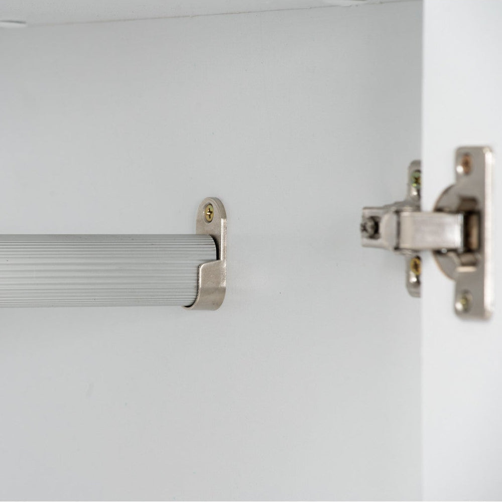 Close-up of a cabinet with a handle and hinge on a white background