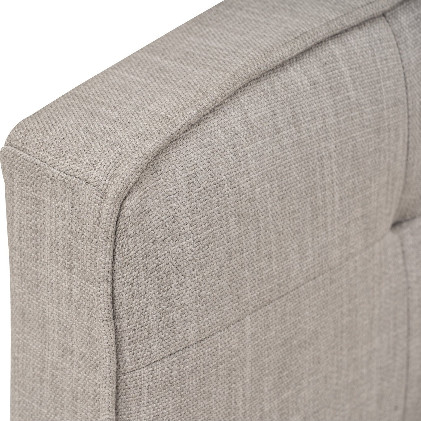 Close-up of a gray upholstered chair corner on a white background
