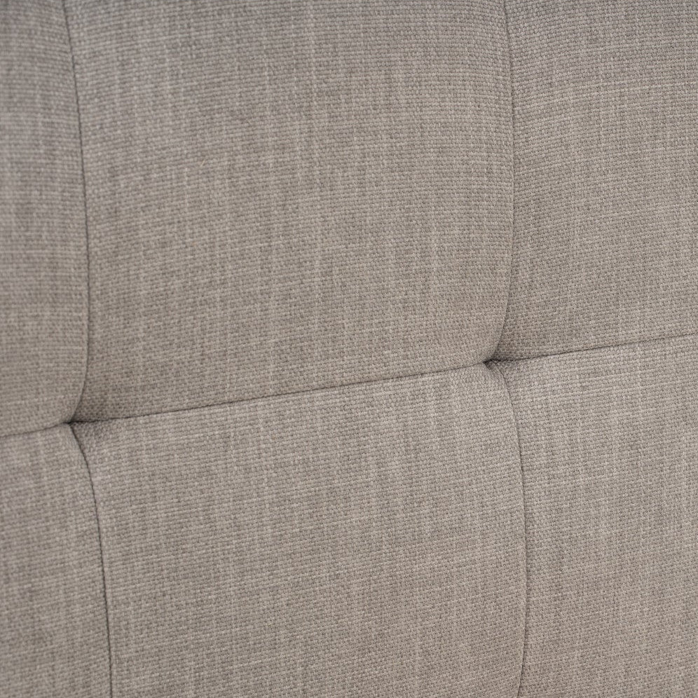 Textured gray headboard with tufted design on a white background