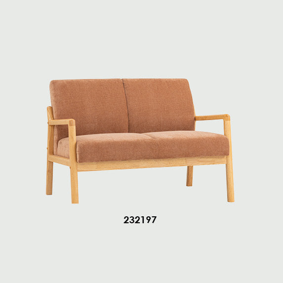 A catalog-style product comparison showing two versions of the ARIA 2 SEATER sofa: one in natural tan fabric with a light wood frame and one in black fabric with a dark wood frame. Text above reads 'ARIA 2 SEATER,' and a small spec table appears at the bottom.