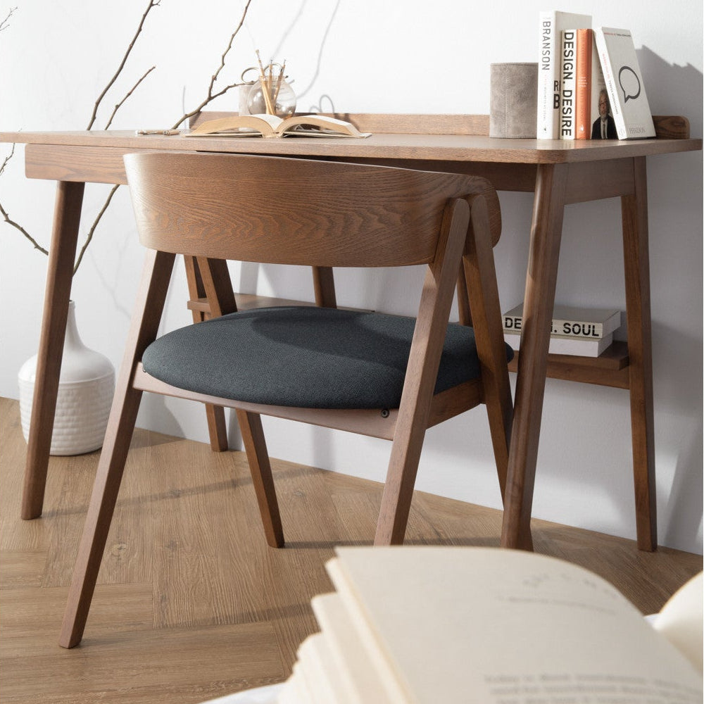 Wooden desk with chair and books in a minimalistic room