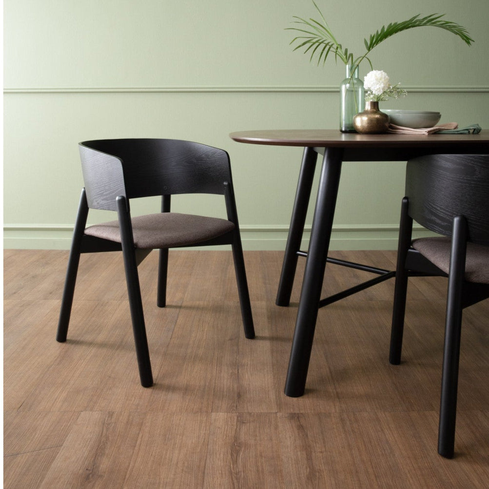 Dining table with chairs against a light green wall