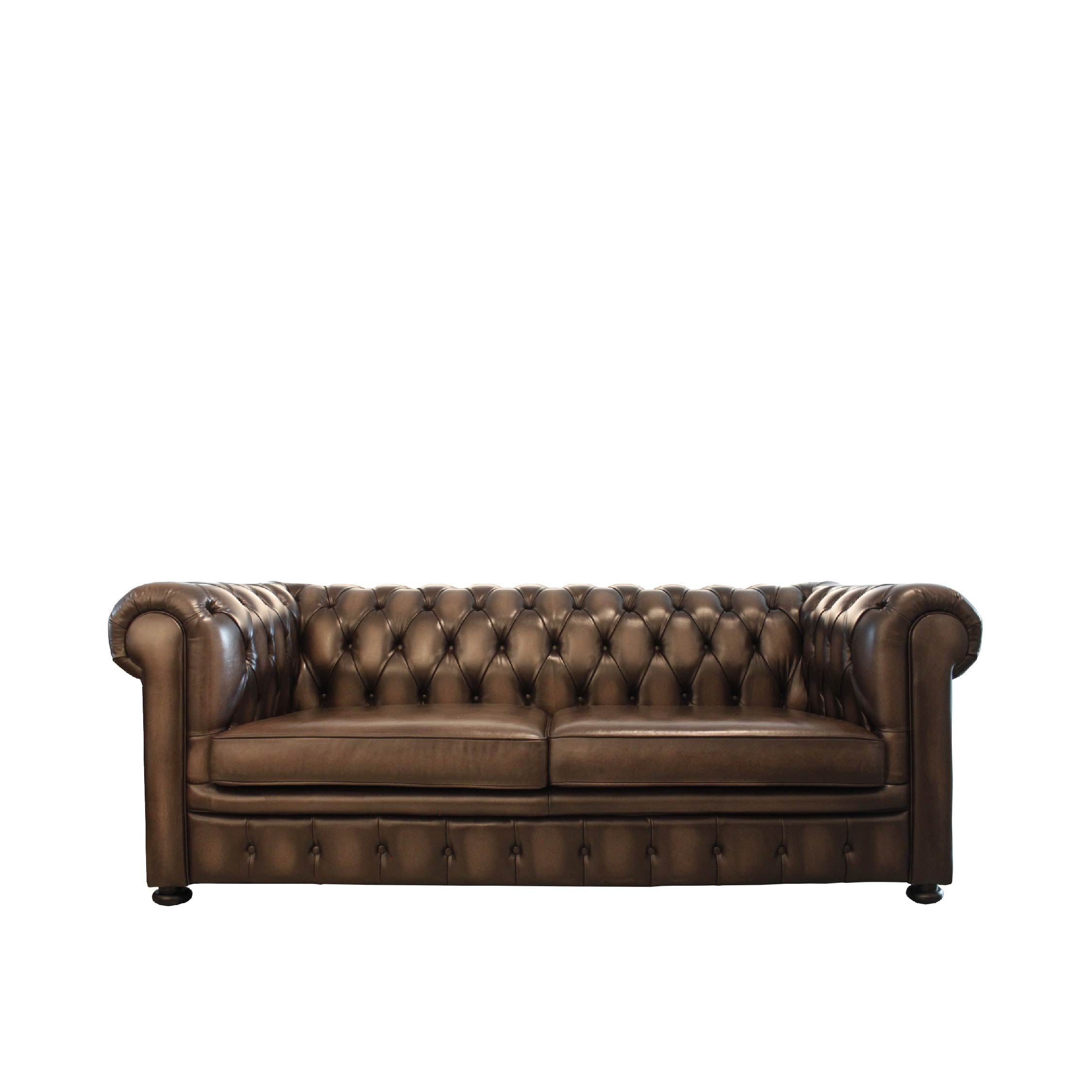 A traditional brown leather Chesterfield sofa with tufted backrest and rolled arms, featuring a hand-antique wash off finish.