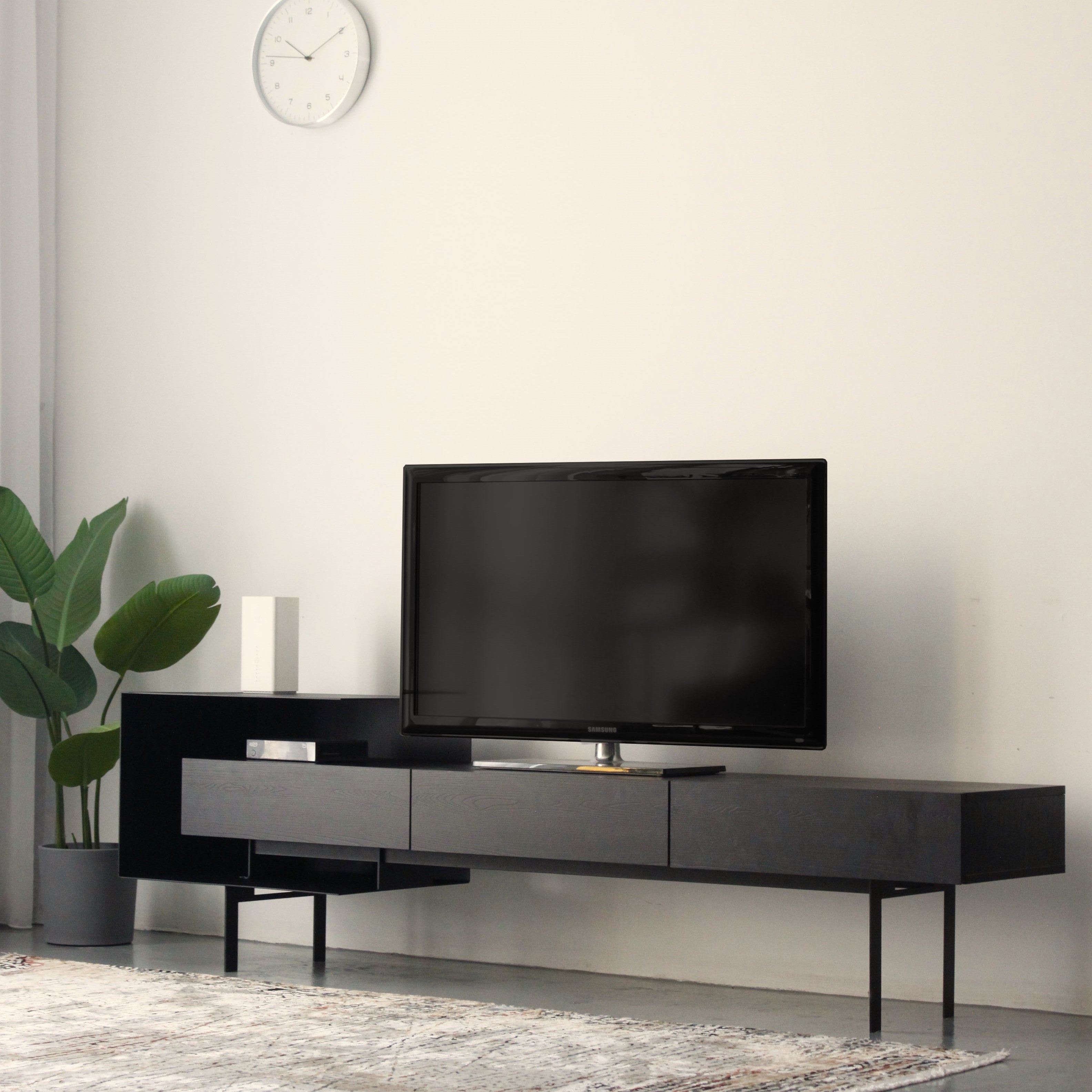 Black TV Cabinet with 3 drawers and a thick metal box on the left and metal leg frame