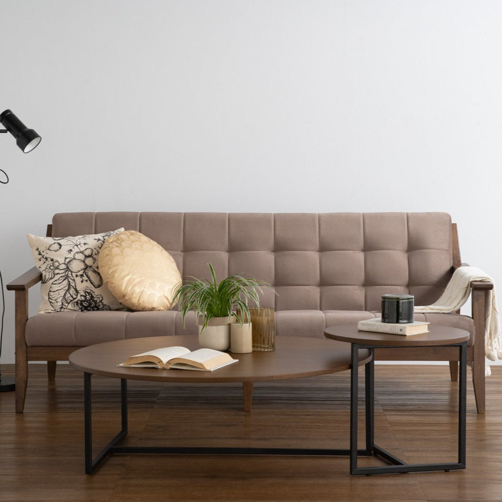 Modern living room with a beige sofa, coffee table, and decorative items.