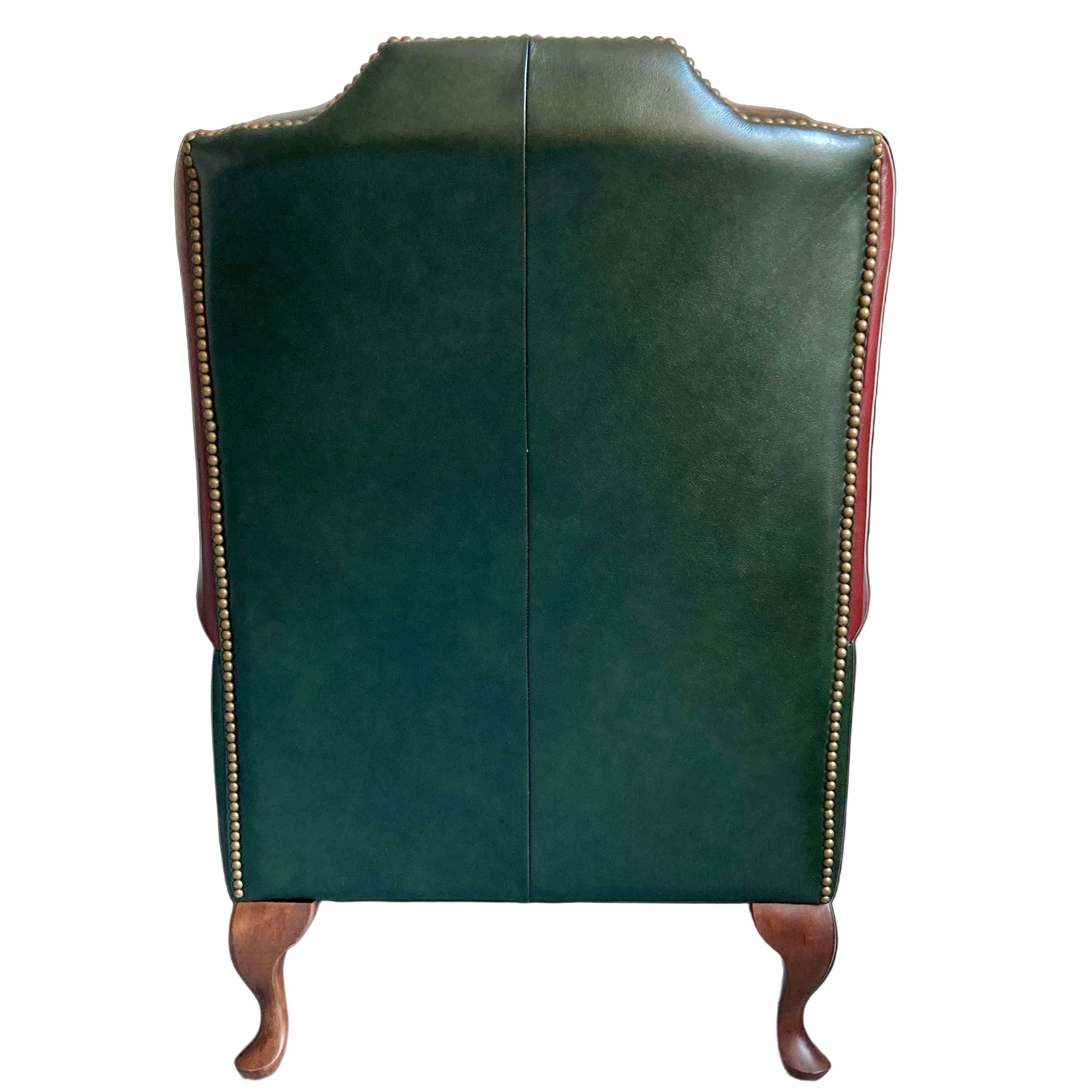 Green leather armchair with wooden legs in a room setting