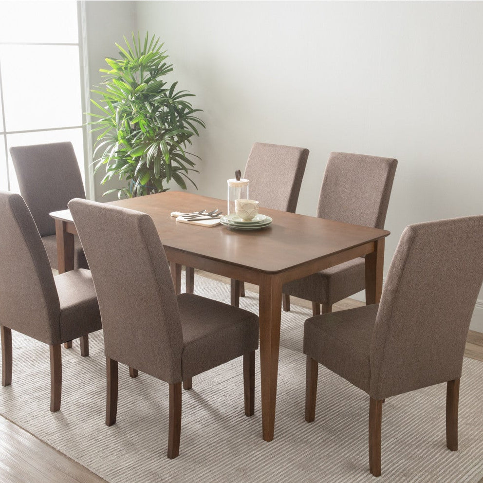 Dining table set with six chairs in a room with a large window and plant.
