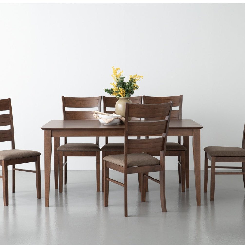 Dining table set with four chairs on a white background