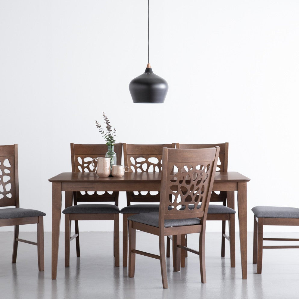 Dining table set with four chairs on a white background