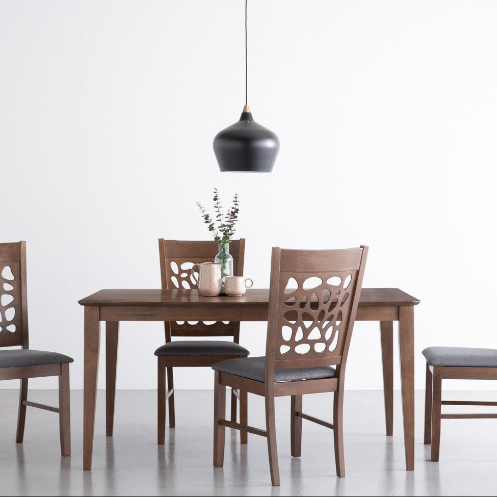 Dining table set with four chairs on a white background