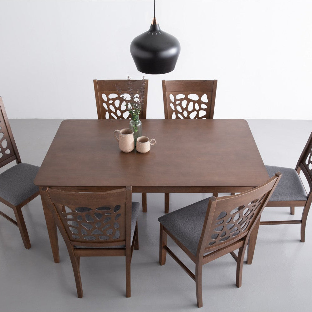 Dining table set with six chairs on a white background