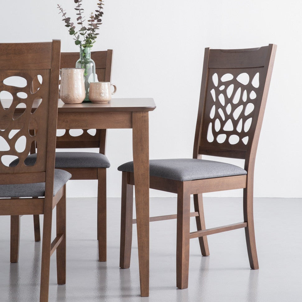 Dining table set with four chairs on a white background