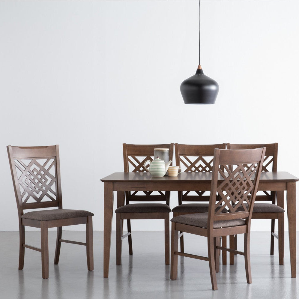 Wooden dining table with four chairs on a white background