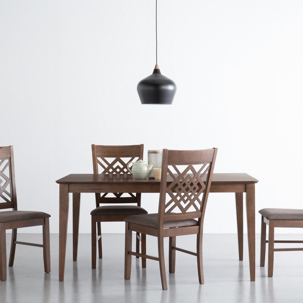 A 5-piece wooden dining set consisting of a rectangular table and four matching chairs with geometric lattice backrests, shown in a minimalist studio setting with a black pendant light overhead.