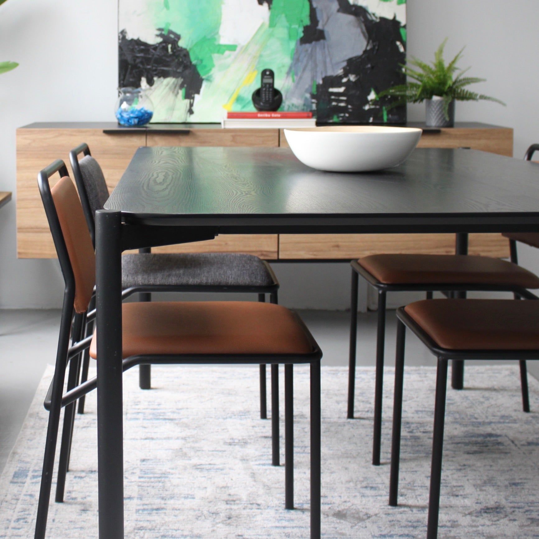 Dining table with chairs in a modern room setting